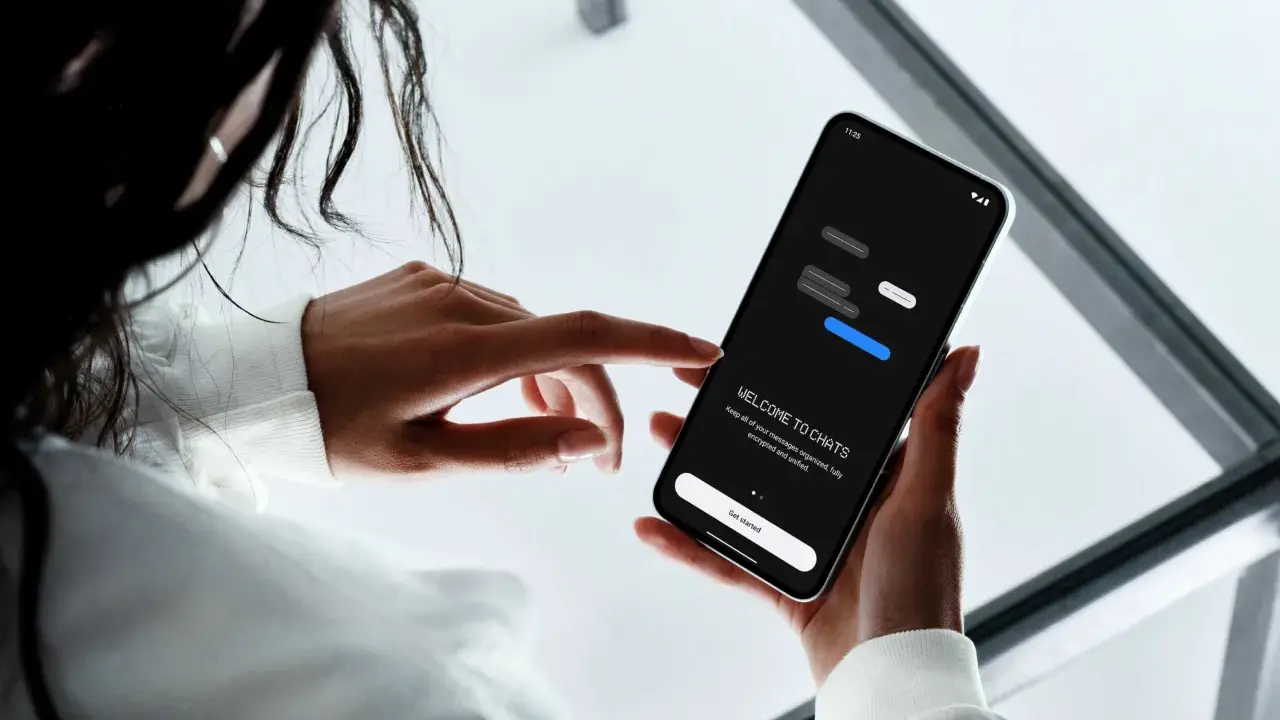 En person håller en mobiltelefon där en chattapp visas. Texten "WELCOME TO CHATS" och "Get started" syns, vilket antyder att man kan skapa grupp sms.